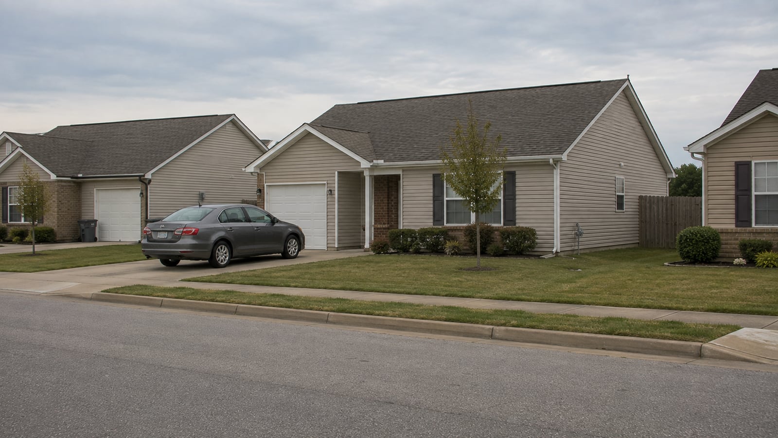 Detached single-family rental home in a newer Arlington Tennessee subdivision with sedan parked in driveway